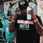 Clyde Carson holding up a cup